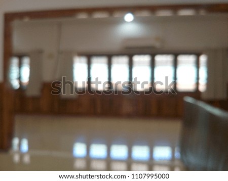 Background image blurred in a room with multiple windows.