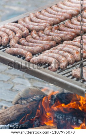 Sausages are grilled using a medieval method in Rothenburg ob der Tauber, Germany. Royalty-Free Stock Photo #1107995078