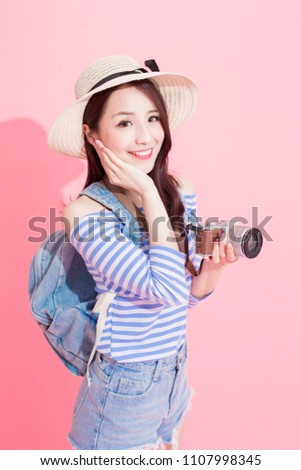 beauty woman take camera and smile happily on the pink background