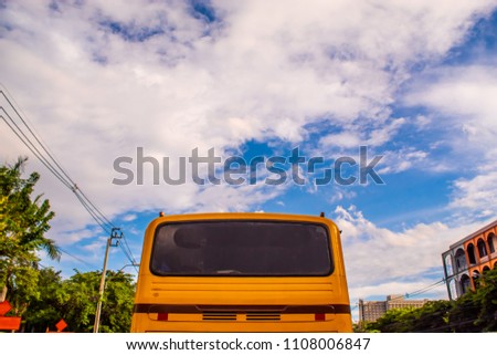 Orange bus and bright blue sky.