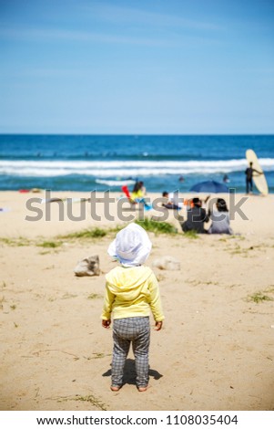Playing in the surf on the beach sand sea waves and sky. East Sea landscape picture of the Republic of Korea.