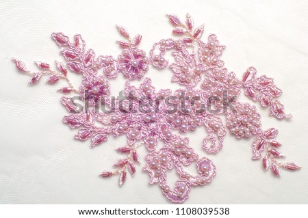 Texture, background, pattern.  Luxury 3D Beaded lace fabric, hand made Pink pearl beads 3D flowers, pink French Embroidered lace, Beads Wedding Lace Royalty-Free Stock Photo #1108039538