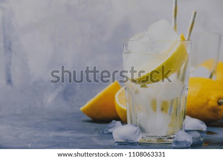 Summer cocktail with soda, gray background, selective focus