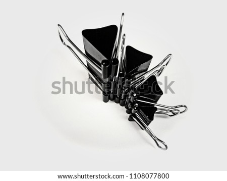 Black paper clips stack on isolate background.