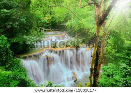 Beautiful waterfall vivid yellow-green color sunlight