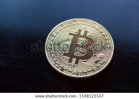 Block chain - Bitcoin curency on blue glass background. Gold metal symbol