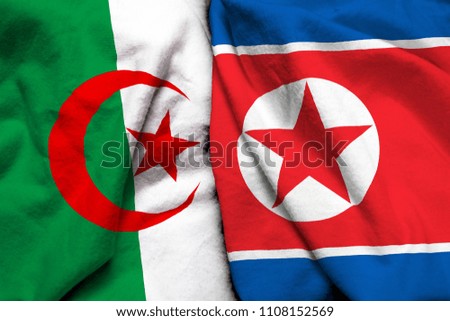 Algeria and North Korea flag on cloth texture