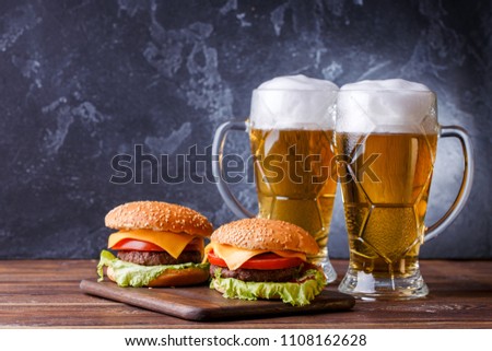 Image of two hamburgers, glasses with beer