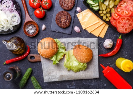 Photo on top of two hamburgers and ingredients