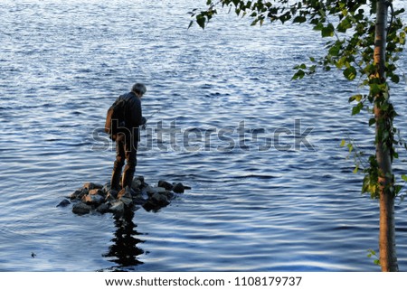 Fisherman at the lake is fishing
