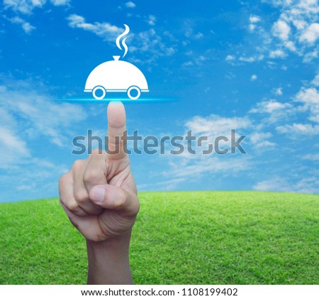 Hand pressing restaurant cloche flat icon over green grass field with blue sky, Food delivery concept