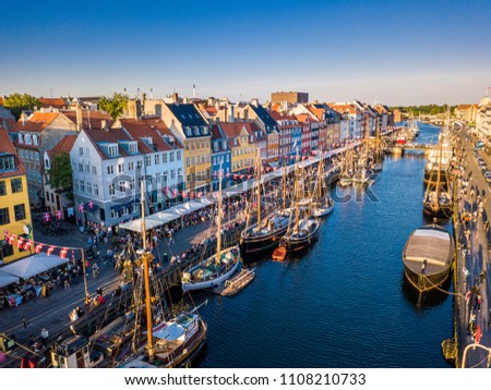 Beautiful historical city center. Nyhavn New Harbour canal and entertainment district in Copenhagen, Denmark. The canal harbours many historical wooden ships. Aerial view from the top. Royalty-Free Stock Photo #1108210733