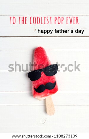 Father's Day greeting card with funny ice cream on white wooden background. To the coolest pop ever!
