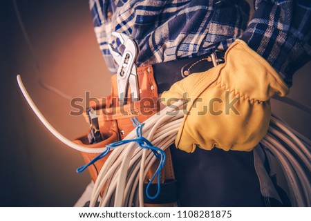 Electrician with Electric Cable Preparing For Installation in the Newly Constructed Building. Royalty-Free Stock Photo #1108281875