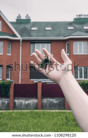 Man holding keys from the big house. Concept of buying a house