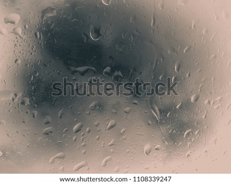rain droplet on car window on white and blue background