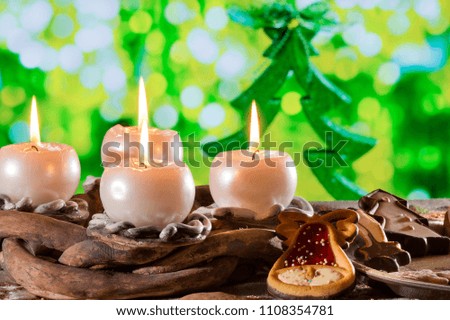 Advent Wreath with Burning Candles in  front of Christmas Tree