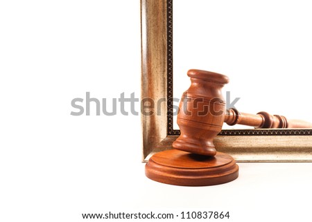 Hammer of auctioneer and decorative frame on white background