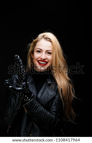 Portrait of smiling blonde in leather jacket