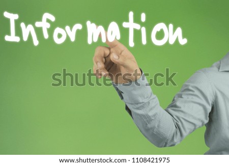 Hand of the businessman pointing to the INFORMATION text on green background and have copy space for design in your work concept.