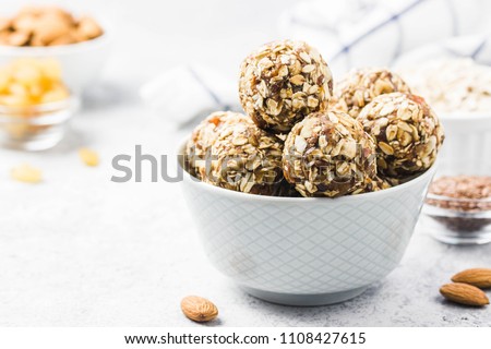 Vegan dessert, raw oatmeal nuts fruit bites. Selective focus, space for text. Royalty-Free Stock Photo #1108427615
