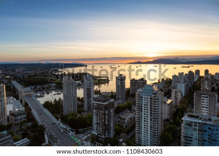 Aerial view of the Downtown City Buildings during the vibrant sunset. Taken in Vancouver, British Columbia, Canada. HDR Processed