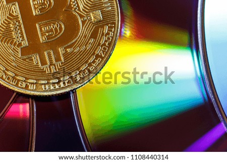 The golden bitcoin on colorful board background, Conceptual image for worldwide crypto currency, huge stack physical version of golden Bitcoin.