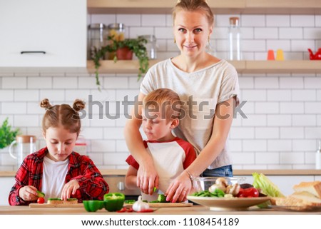 Image of mother with daughter and son cooking at table
