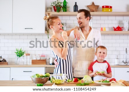 Picture of parents and young son preparing food in kitchen