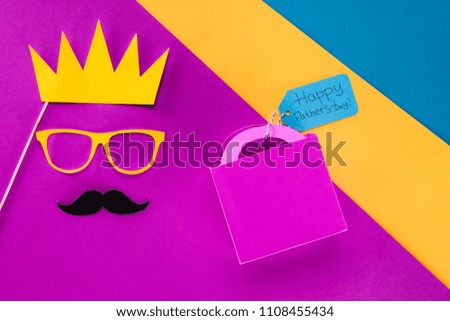 top view of king face with gift box with Happy fathers day tag on colorful surface