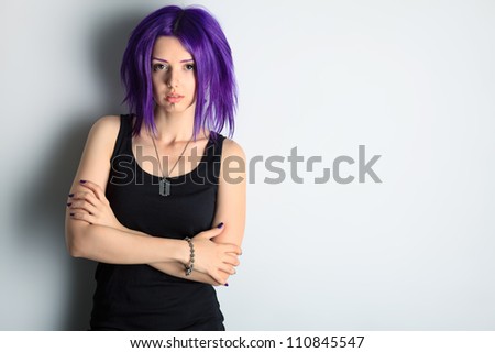 Portrait of a punk girl with purple hair.