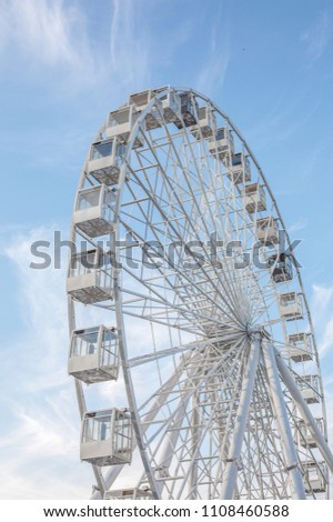 White ferris wheel on blue sky background amusement park
swing happiness ladder to the sky design cabins