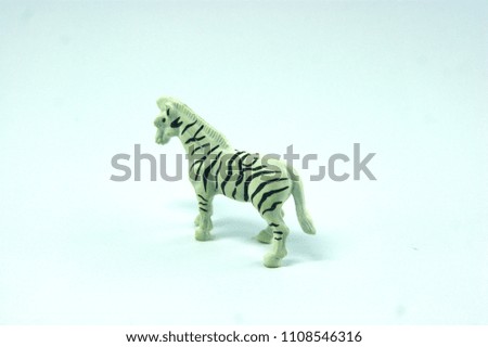 small zebra plastic model isolated in blue degradation background 