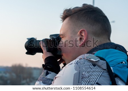 A photographer takes pictures on camera