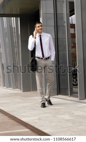 Businessman using a smartphone on the street