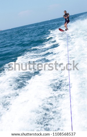 Attractive young man is skiing on water