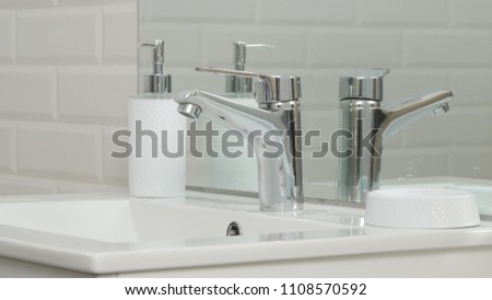 Modern Bathroom Picture with Sink and Faucet with Flowing Water
