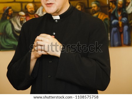 Priest in black cassock with clerical collar prays Royalty-Free Stock Photo #1108575758
