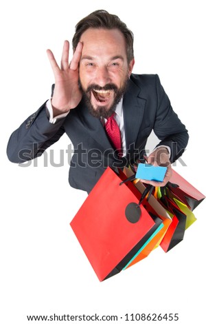 Crazy Discounts time for shopping. Amazed sales period. Attractive businessman with shopping bag and credit card in hands. Salesman shocked with sales proposal Isolated on white background.