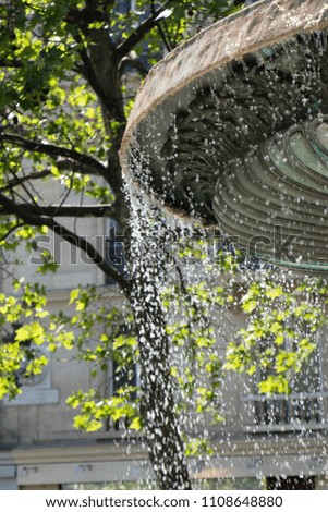 Fountain with running water at summer time in the city