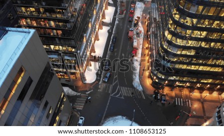 Moscow White square modern business center. Winter evening smooth aerial shot. Cars and people moving at the intersection.
