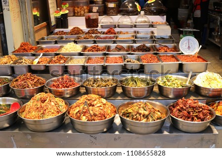 Varieties of kimchi on display at Dongmun Traditional Market in Jeju Island,South Korea.Kimchi is a Korean traditional side dish made from salted and fermented vegetables including chili powder. Royalty-Free Stock Photo #1108655828