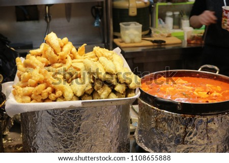 The Korean dishes ,Kkanpung (fried shrimps),Twigim (fried vegetables) and Tteokbokki (spicy stir-fried rice cakes) on display at Dongmun Traditional Market in Jeju Island,South Korea. Royalty-Free Stock Photo #1108655888