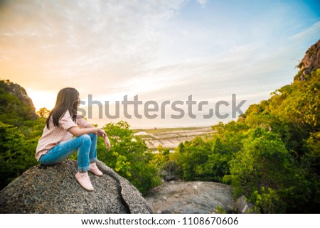 Photographer women enjoying sunrise on mountain,Nature landscape