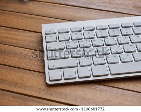 Wooden board with white keyboard
