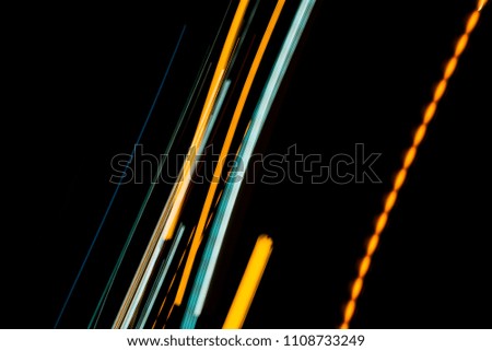 Orange and bluel backdrop from fast moving glow particles.stripes and Lights   moving fast over dark background. 