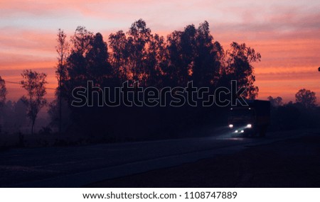 A large truck is running in the street in the early morning isolated unique photo