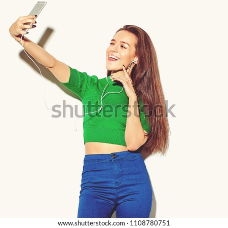 portrait of beautiful happy cute brunette woman girl in casual green hipster summer clothes with no makeup isolated on white,take a selfie and showing her tongue