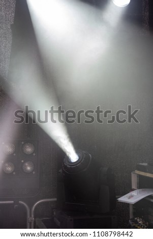 stage of musicians with black white lamps beams and background