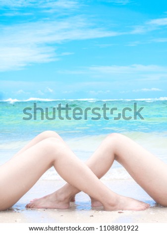 Woman relaxing on resort sandy beach near to turquoise sea water in thailand